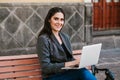 Latin woman working with her laptop and coffee in a colonial city in Latin America Royalty Free Stock Photo