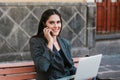 Latin woman working with her laptop and coffee in a colonial city in Latin America Royalty Free Stock Photo