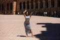 Latin woman, young and beautiful brunette is posing in a famous square in seville known internationally all over the world. The