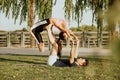 Latin woman and Caucasian man do yoga exercises in a park in Madrid. Balance and concentration in couple