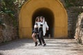 Latin women couple, young, dancing bachata with the entrance of a tunnel in the background in an outdoor park, performing Royalty Free Stock Photo