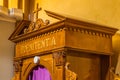 Latin word on a wooden confessional