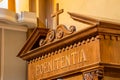 Latin word on a wooden confessional