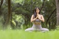 Latin young girl, doing yoga poses in the park outdoors