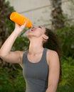 Latina Drinking from Orange Sports Water Bottle Royalty Free Stock Photo