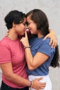 Latina Lesbian Couple Smiling And Hugging Outside