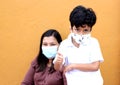 Latina mom woman with 6 year old boy wearing protective face masks by covid-19 Royalty Free Stock Photo