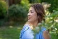Latina Mother Smiling in Back Yard in front of red leaved bush Royalty Free Stock Photo