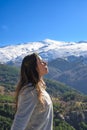 latina woman,long hair,breathing fresh air at the top of the mountain,sierra nevada spain