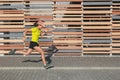 A Latina woman sprints in a race. Runner