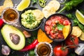 Latinamerican food party sauce guacamole, salsa, chips and tequi Royalty Free Stock Photo