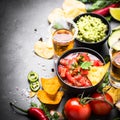 Latinamerican food party sauce guacamole, salsa, chips and tequi Royalty Free Stock Photo