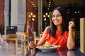 Latinamerican girl have a lunch in restaurant