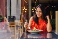 Latinamerican girl have a lunch in restaurant