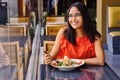 Latinamerican girl have a lunch in restaurant