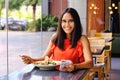 Latinamerican girl have a lunch in restaurant