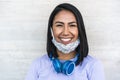 Lating millennial girl smiling in front of camera while wearing face protective mask - Health care and new coronavirus lifestyle Royalty Free Stock Photo