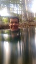 Latino adult man swims in crystal clear spring water of the Media Luna natural lagoon in the municipality Royalty Free Stock Photo