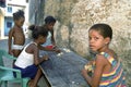 Latino children play Domino in slum, Recife, Brazil