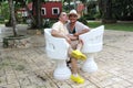 Couple sitting on a bench confidant chairs in Merida in Yucatan Mexico show their love with flirtatious looks and kisses