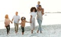 Latino family, beach and walking on summer vacation, quality time and bonding for fun and wellness. Grandparents, mother
