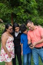 Latino family with two teenagers uses cell phone to make a video call Royalty Free Stock Photo