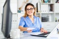 Latino female doctor working with patient