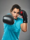 Latino female fighter delivering a jab