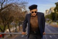 Latino gay male with makeup wearing trendy hat looking aside Royalty Free Stock Photo