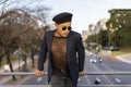 Latino gay male with makeup wearing trendy hat looking aside Royalty Free Stock Photo