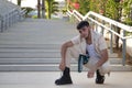 Latino and Hispanic boy, young and nonconformist, rebellious, with beige jacket and pants, crouching, posing looking at the camera Royalty Free Stock Photo