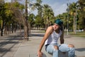 Latino and Hispanic boy, young, rebellious, with headscarf, sitting on a bench, alone, sad and pensive. Troubled concept, rebel,