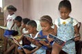 Latino kids reading picture books of Miffy, Brazil