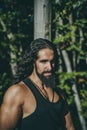Latino male. Young handsome man with long hair beard, mustache and trendy hairdo.