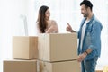 Latino man with beard and Asian woman couple help to carry packed cardboard boxes into their new home and thumbs up to each other Royalty Free Stock Photo