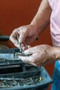 latino man looking for tools in his toolbox, hispanic, with screwdriver in hand