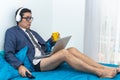 Latino man with tie and underwear works at home with his computer