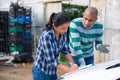 Man and woman farmers talking near car Royalty Free Stock Photo