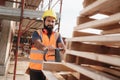 Latino Manual Worker With Forkift Pallet Stacker In Construction Site