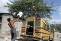 Latino men loading roof bus with boxes Royalty Free Stock Photo