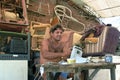 Latino repairer works in his repair shop, Brazil