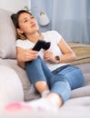 Latino woman with glass of red wine watching tv Royalty Free Stock Photo