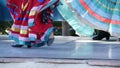 Latino women in colourful traditional dresses dancing Jarabe tapatio, mexican national folk hat dance. Street