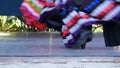 Latino women in colourful traditional dresses dancing Jarabe tapatio, mexican national folk hat dance. Street