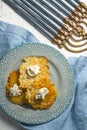Latkes and curd cheese on a plate, Hanukkah close-up