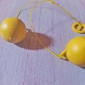 Lato-lato is a traditional toy consisting of a pair of plastic or rubber balls attached to a string to form a pendulum.