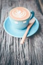 Latte art, Blue coffee cup on wooden background