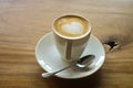 Latte art on a cappucinno , on wooden table Royalty Free Stock Photo