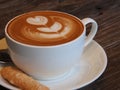 Latte art coffee and biscuit Royalty Free Stock Photo