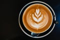 Latte art coffee in black cup on  black table Royalty Free Stock Photo